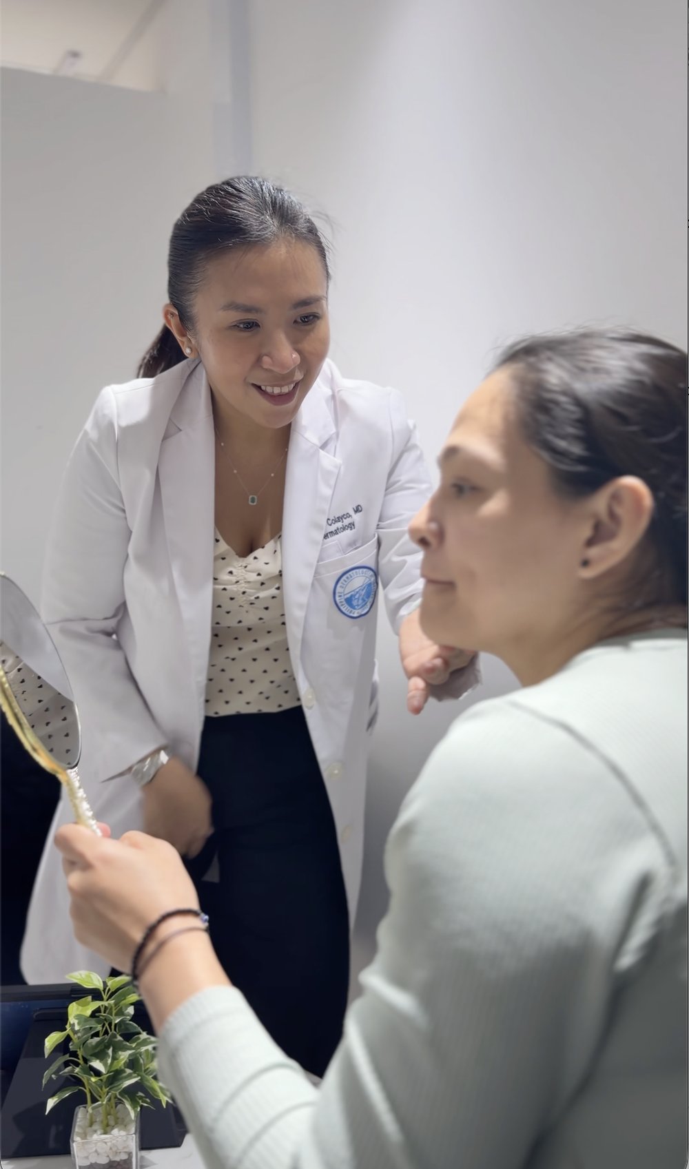 Our dermatologist checking a client's skin with her
